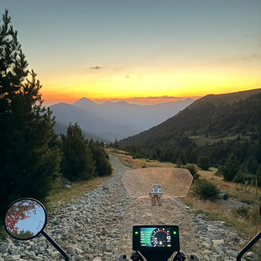 First-person view down a rocky Kosovo trail at sunset