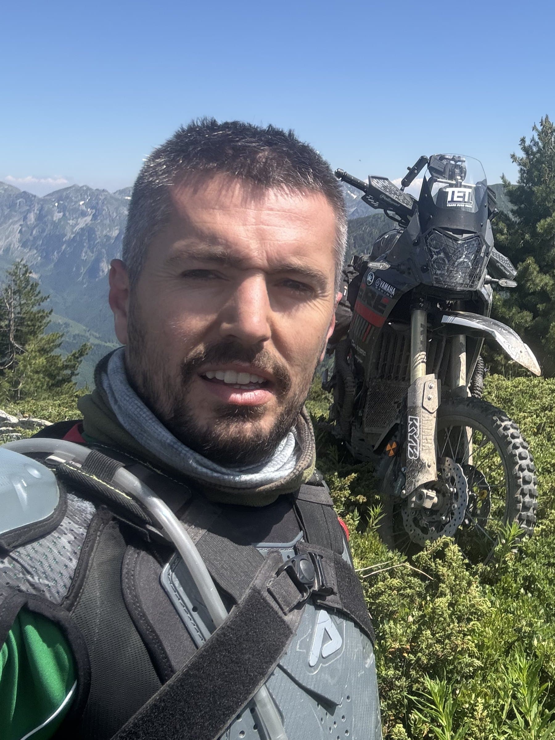 Qendrim Graiçevci — TAD Adventure co-lead guide on a mountain ridge in Kosovo with his Yamaha Ténéré