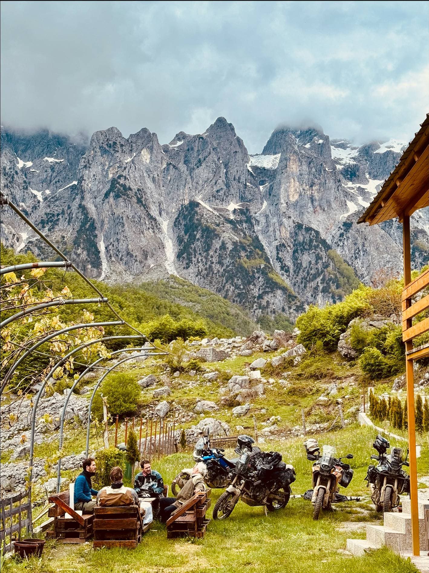 Mountain lodge with dramatic peaks and riders relaxing
